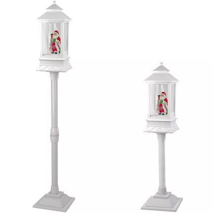 Kalėdinė dekoracija žibintas su Kalėdų Seneliu ir baltu automobiliu, giedamos giesmės