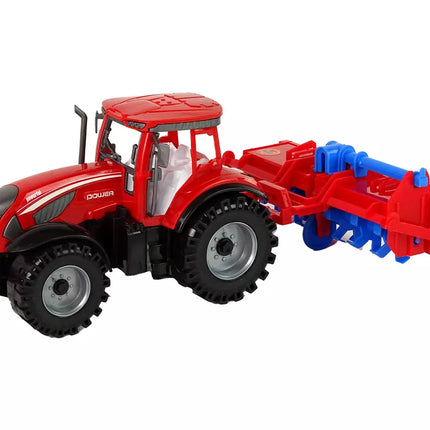 Raudonas traktorius su plūgu, frikcinis variklis