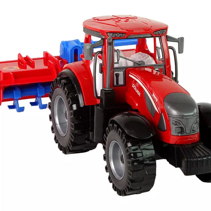 Raudonas traktorius su plūgu, frikcinis variklis