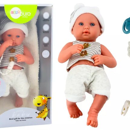 Lėlė su baltais ir pilkais drabužiais, kepure, čiulptuku ir antklode