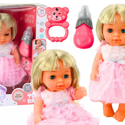 Lėlė su šviesiai rožine suknele, kuri sysioja, buteliukas, barškučio garsai