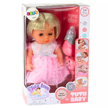 Lėlė su šviesiai rožine suknele, kuri sysioja, buteliukas, barškučio garsai