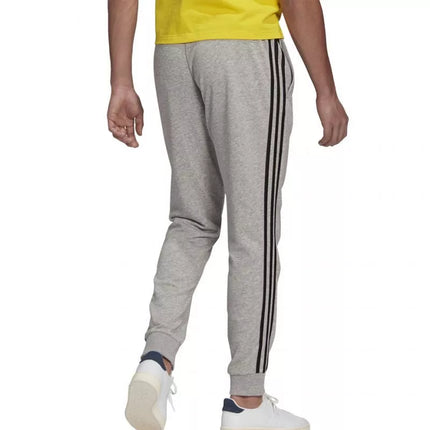 Adidas Essentials Kelnės su siaurėjančiais rankogaliais ir 3 juostelėmis M GK8889