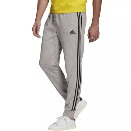 Adidas Essentials Kelnės su siaurėjančiais rankogaliais ir 3 juostelėmis M GK8889
